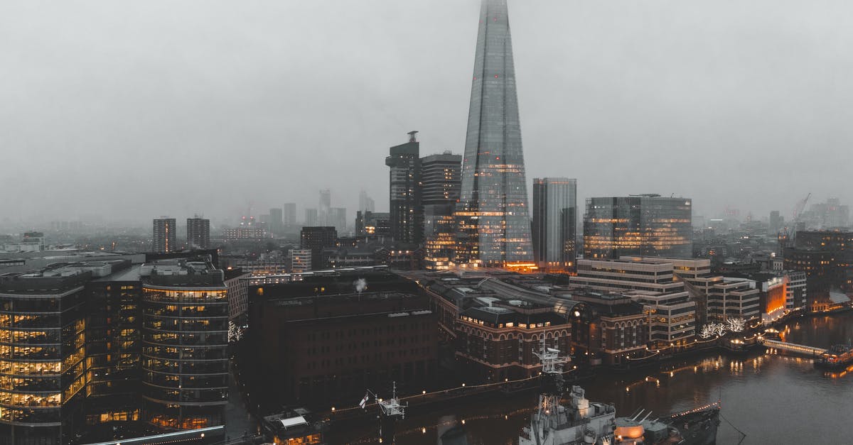 Extending 7 day London Oyster card for extra zones - Cityscape of river with ship near buildings in foggy weather