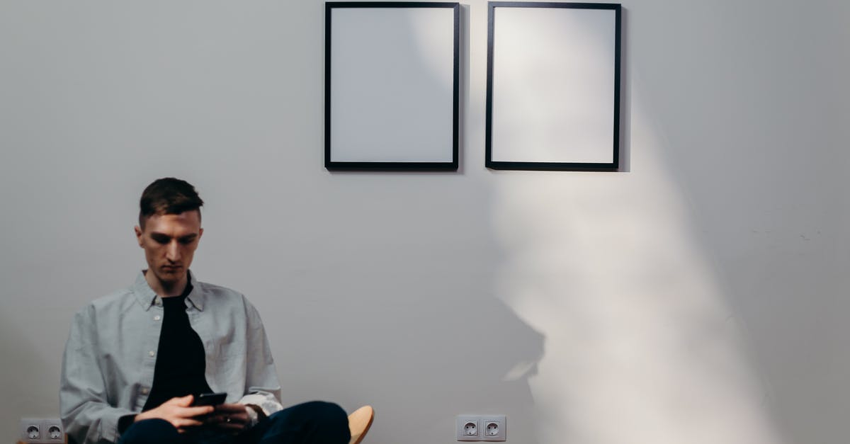 Extending visitor stay in the US - Man in Gray Dress Shirt Sitting on Yellow Chair