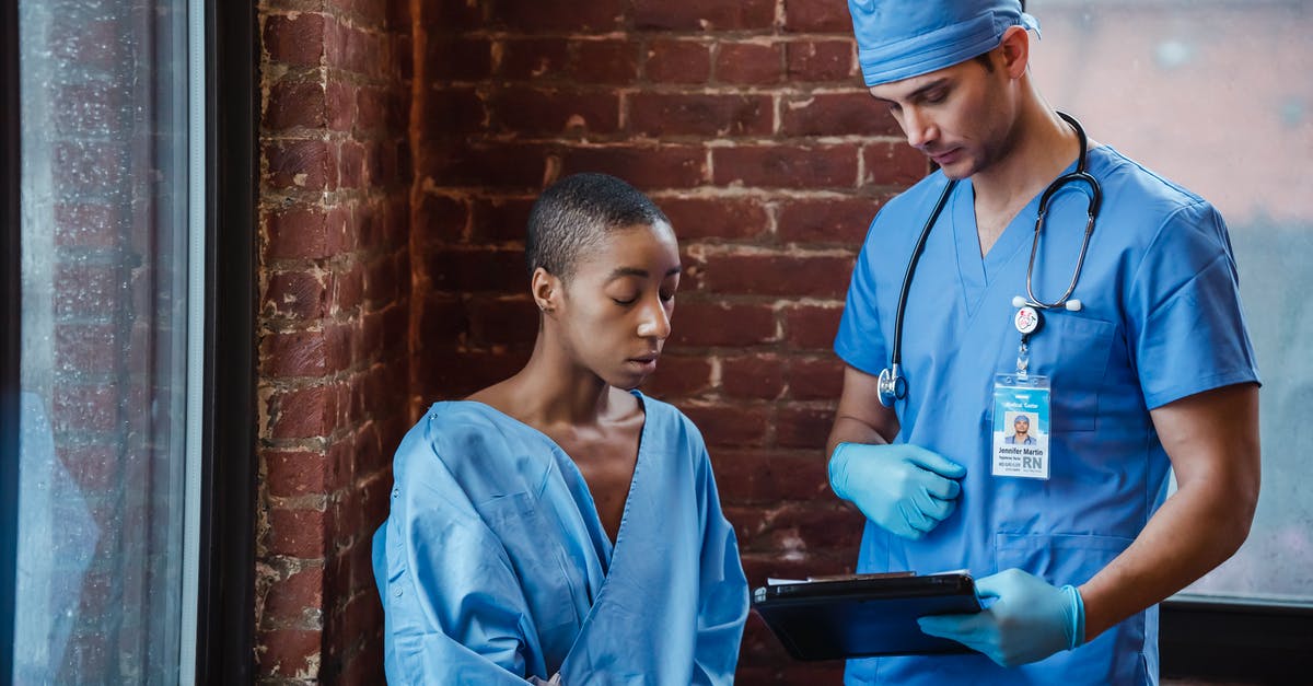 Failing to show EHIC at foreign European hospital - Doctor showing diagnosis to black woman patient in hallway of clinic