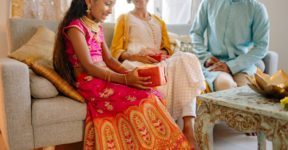 Family booking of 35-40 people on Indian Railways - is it possible? - A Happy Girl Sitting Beside Her Parents while Looking at the Gift she is Holding