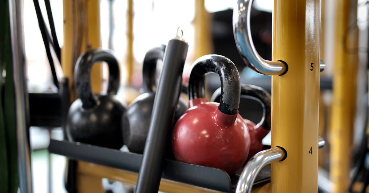 Family Visit Round 3 [closed] - Set of different kettlebells placed in row on metal platform on modern fitness equipment in sport center