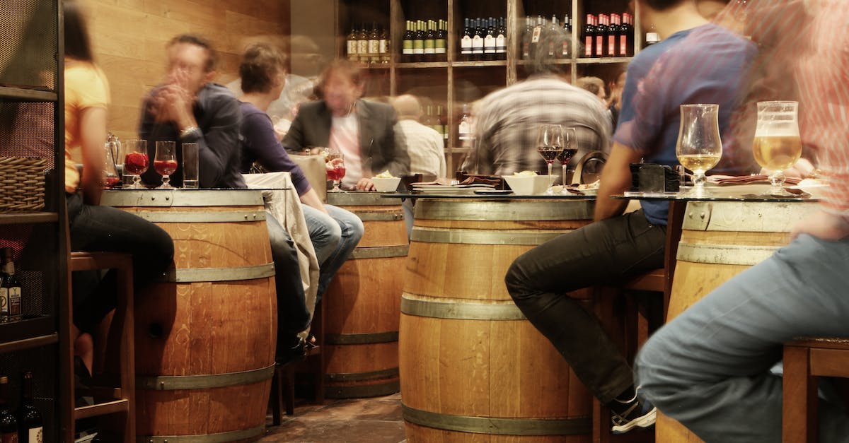 Favourite tapas bars in Barcelona [closed] - Person Sitting Near the Brown Wooden Barrel Table