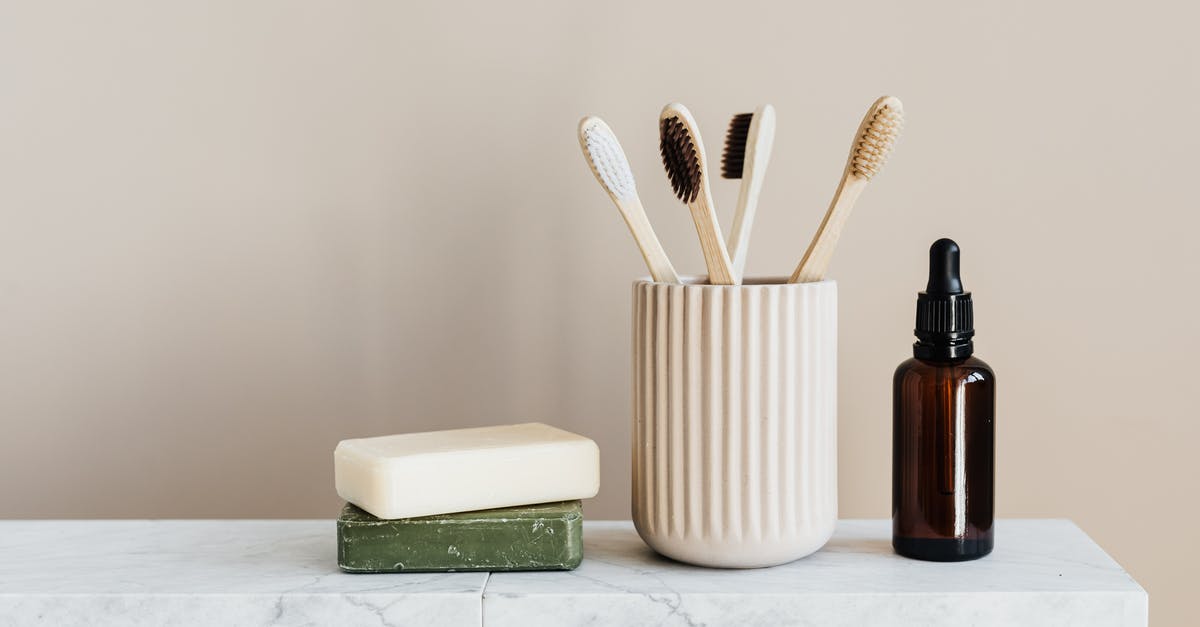 Fedex Taiwan bound duties, taxes on personal package? - Collection of organic soaps and bamboo toothbrushes in ceramic minimalism style holder placed near renewable glass bottle with essential oil on white marble tabletop against beige wall