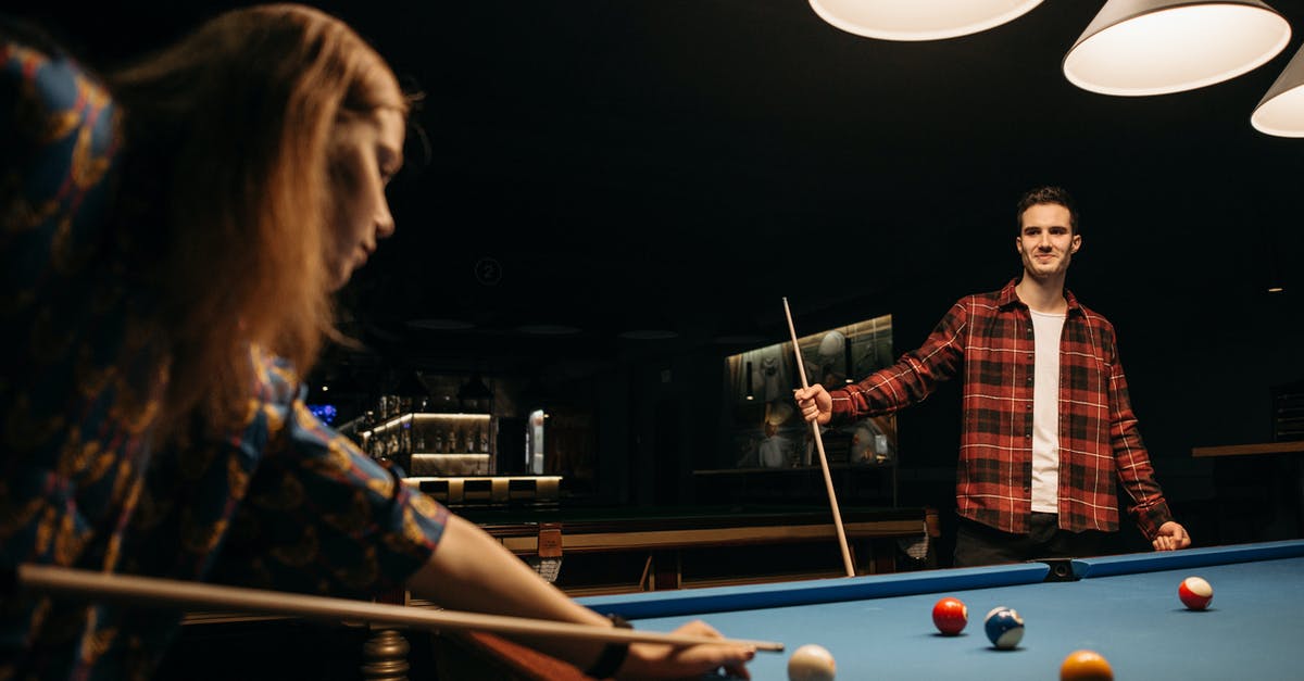 Fee-free ATMs in Singapore? - Woman in Red and Black Plaid Dress Shirt Playing Billiard