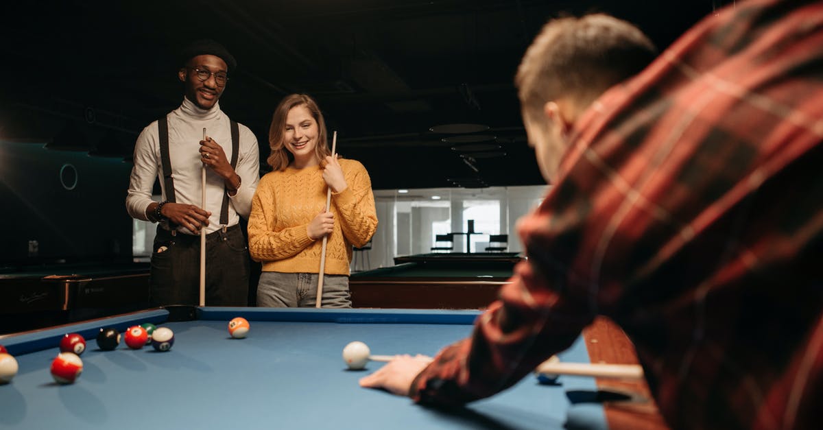 Fee-free ATMs in Singapore? - Man in Red and Black Jacket Playing Billiard