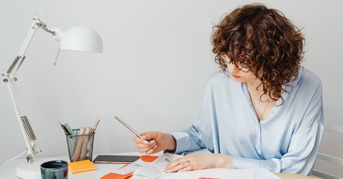 Financial proof papers for schengen visa - Woman Checking Receipts on Wooden Table