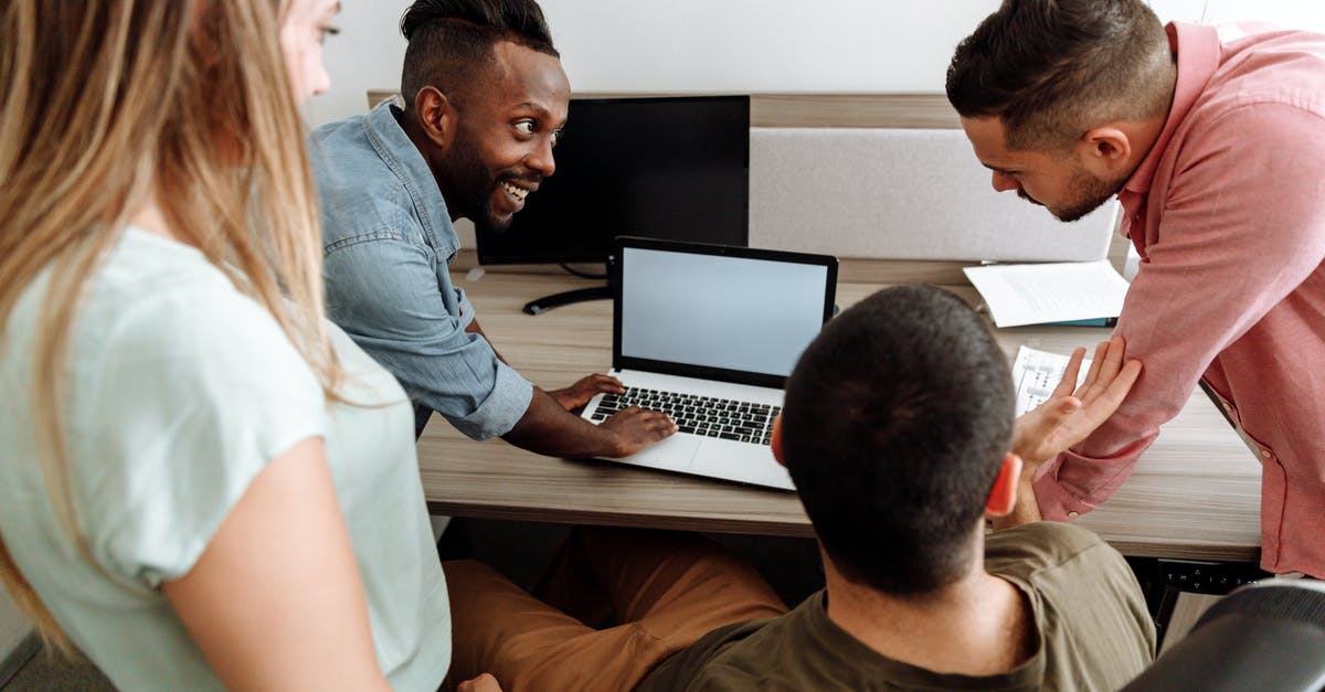 Finding a laptop lost while on board a flight? - Group Of People Having Discussion At Work