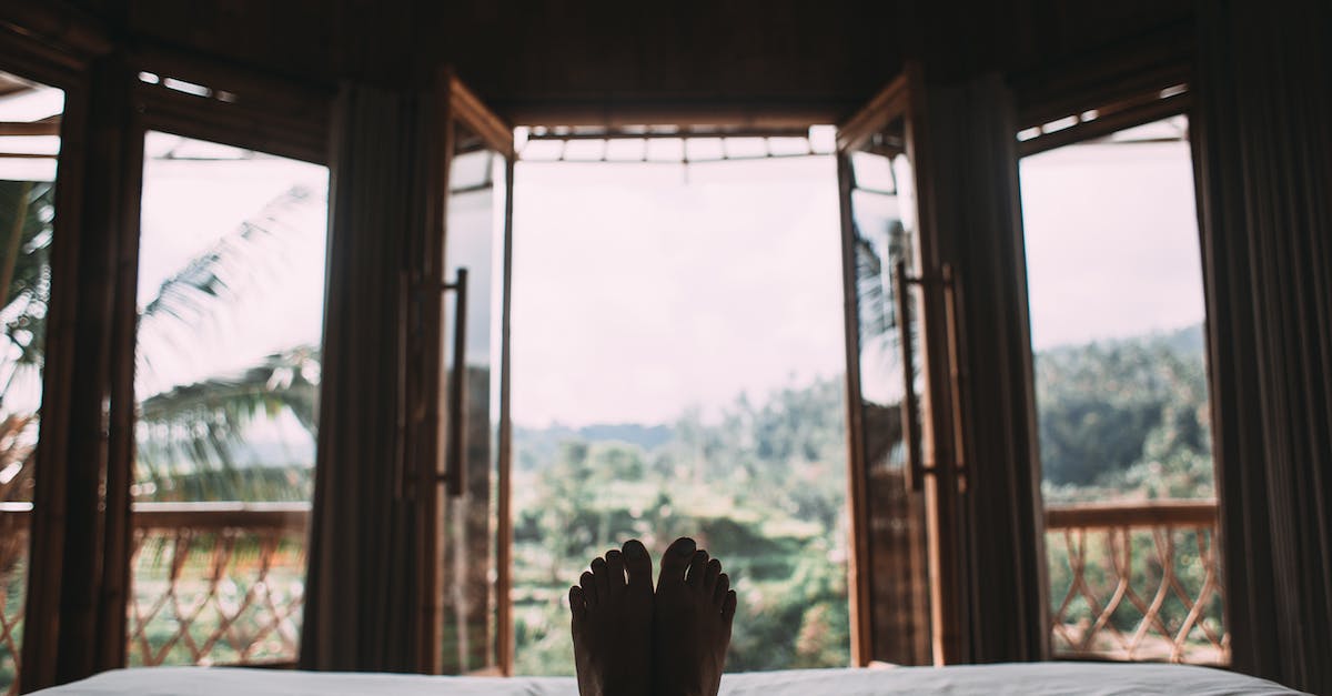 Finding a quiet hotel in Madrid - Faceless person resting on bed in room