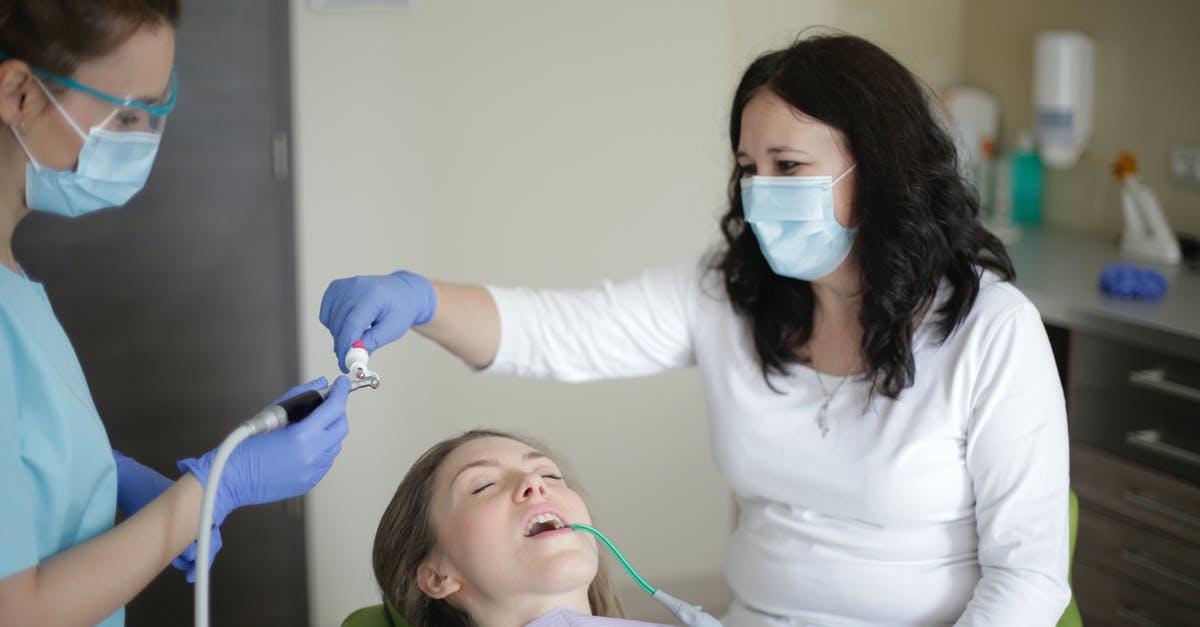 Finding job on Visit visa [closed] - Middle aged female lying in dental chair with tube suction in mouth while getting professional treatment to fill cavity in tooth in dental clinic
