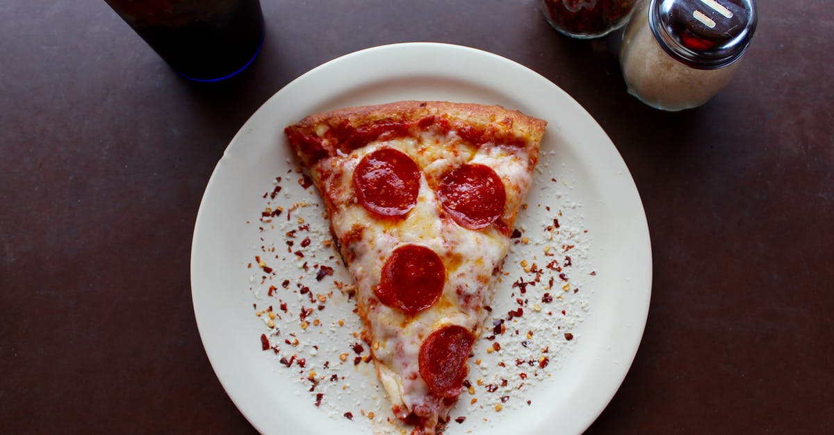 Finding Tella in Ethiopia (on fasting days) - Sliced Pepperoni Pizza on White Ceramic Plate