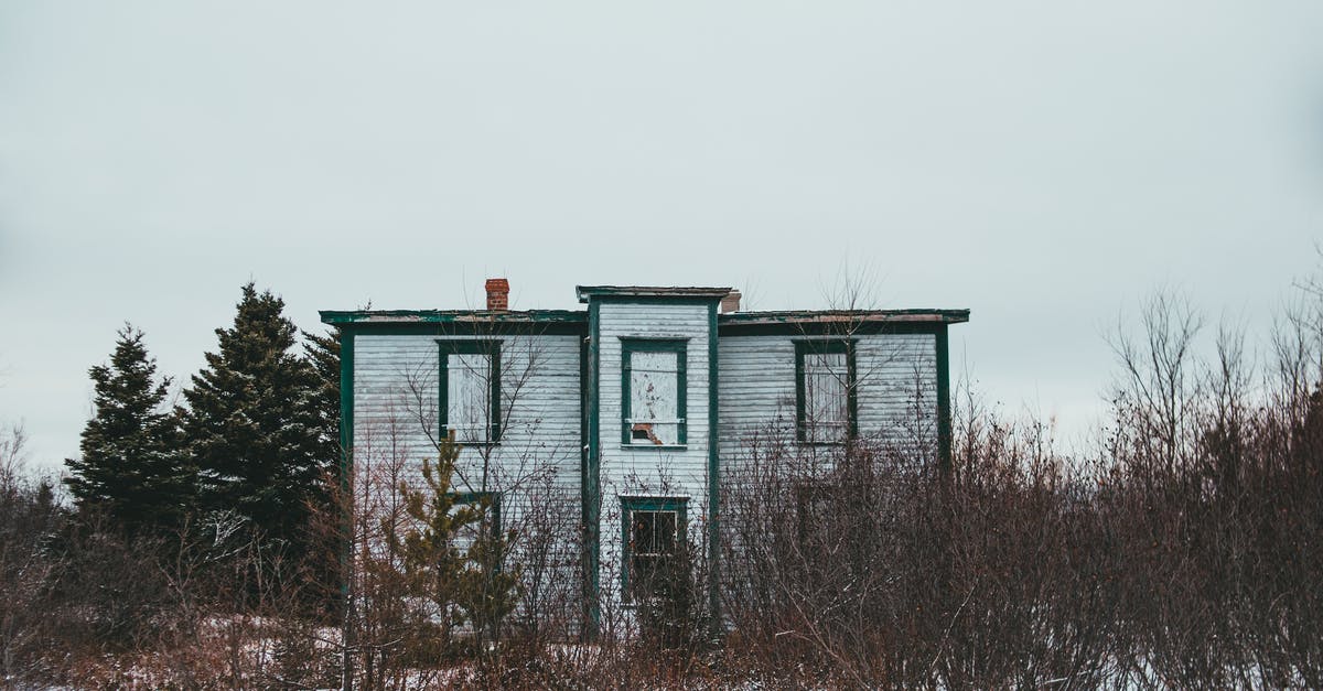 FIR for damaged Indian passport? - Old house facade among dry bushes and coniferous trees