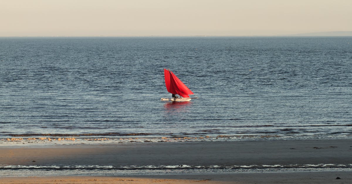 Firearm carried aboard an ocean going sailboat - Red and White Sailboat on the Sea