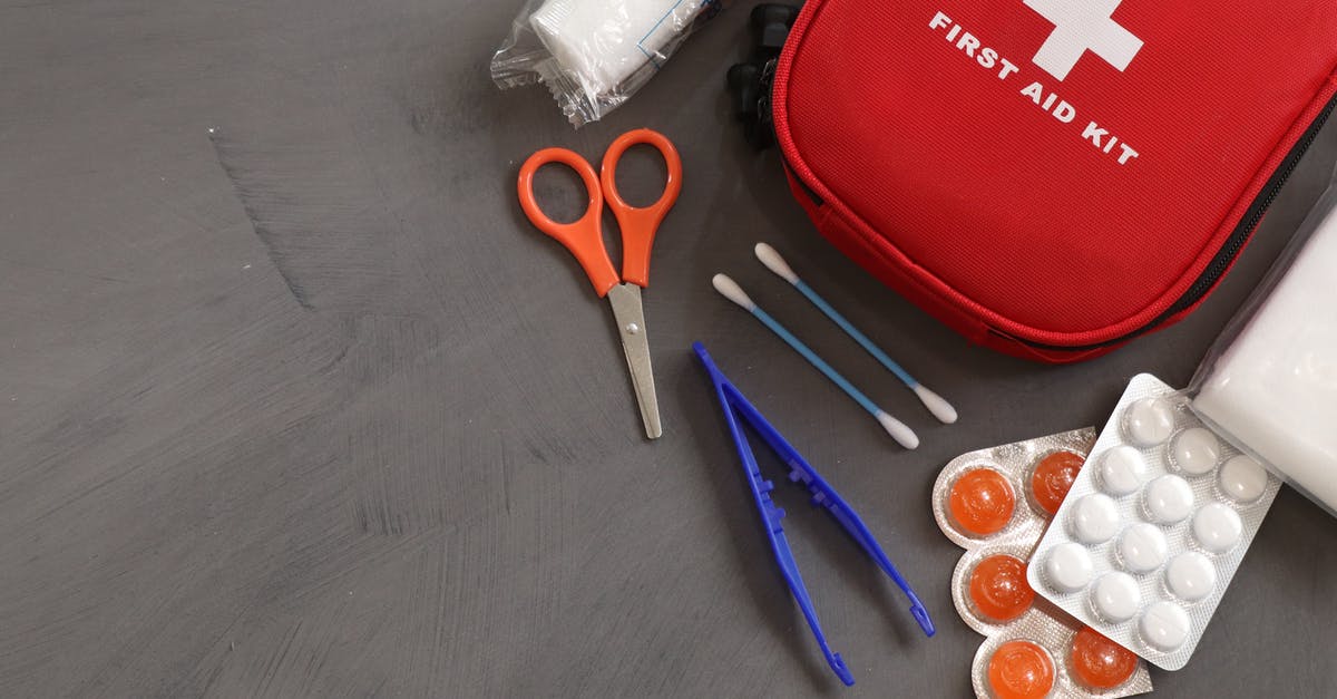 First aid scissors confiscated by Dubai airport security - First Aid Kit on Gray Background