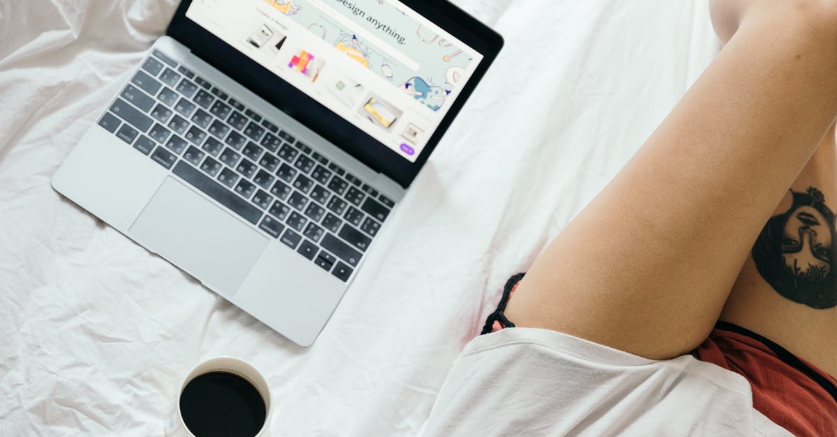 First leg of connection delayed. Can I claim compensation? - From above of unrecognizable woman with tattoo on leg  browsing netbook and drinking coffee while resting on bed in cozy bedroom