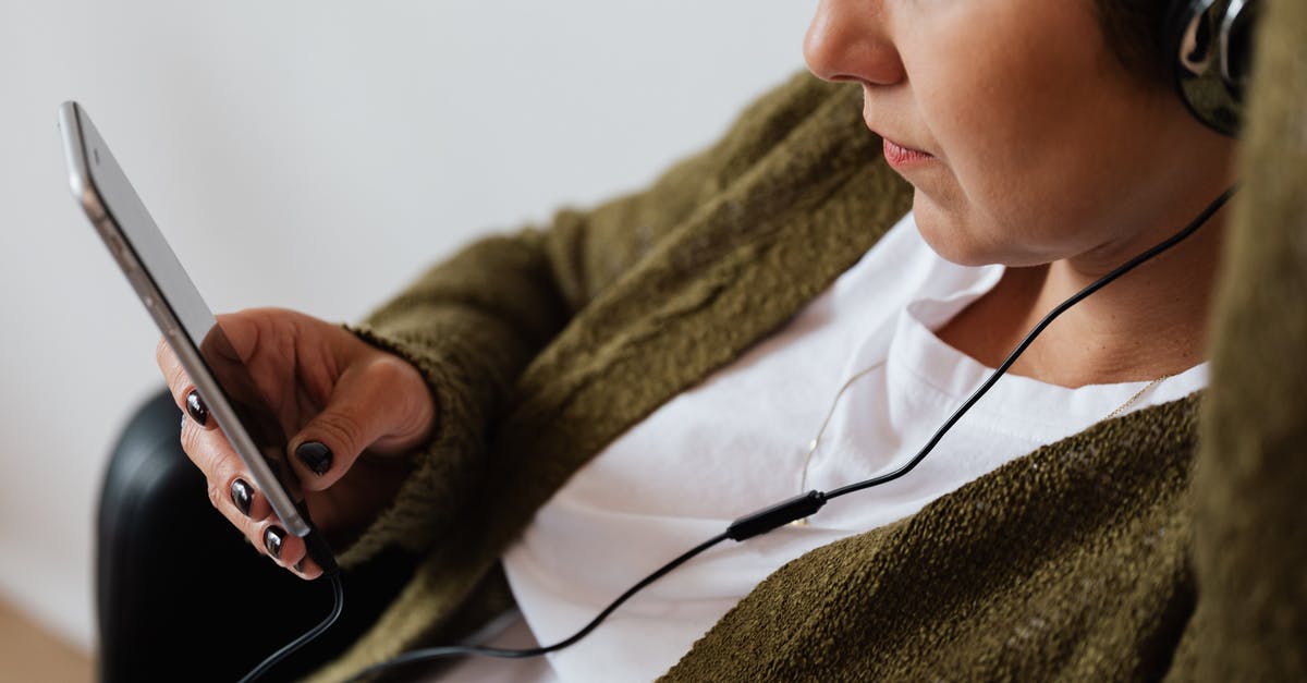 First time Schengen Visa application for france - Crop woman using smartphone and listening to music in headphones