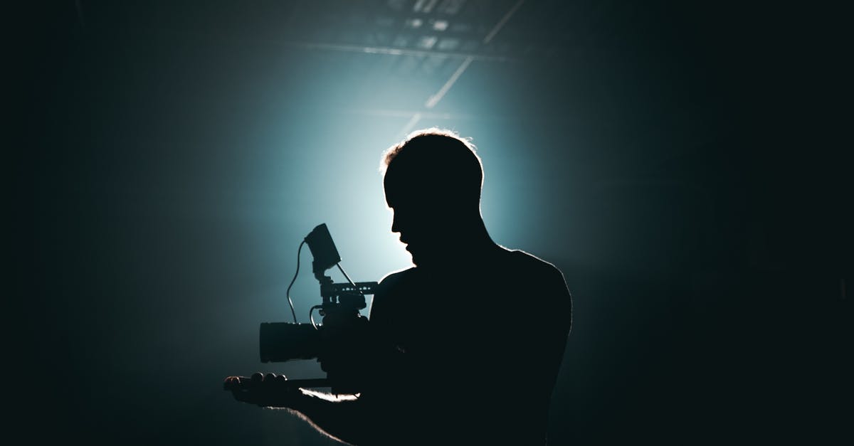 First-Time Greyhound Traveller - Silhouette of Man Standing in Front of Microphone