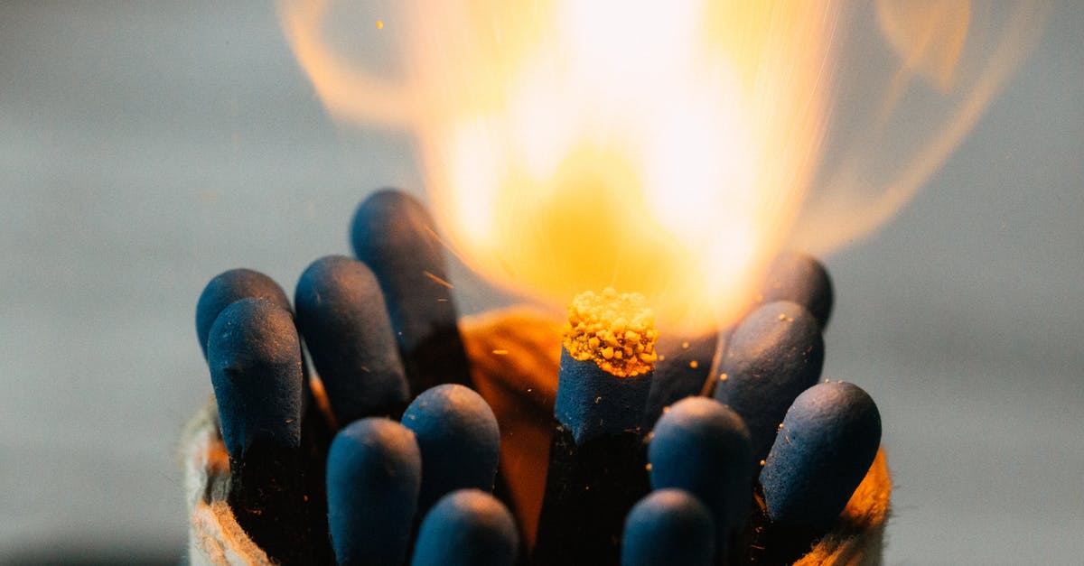 Flashing yellow beacon in Canada - Closeup of burning fire on match head among pile of black matches in jar on blurred background