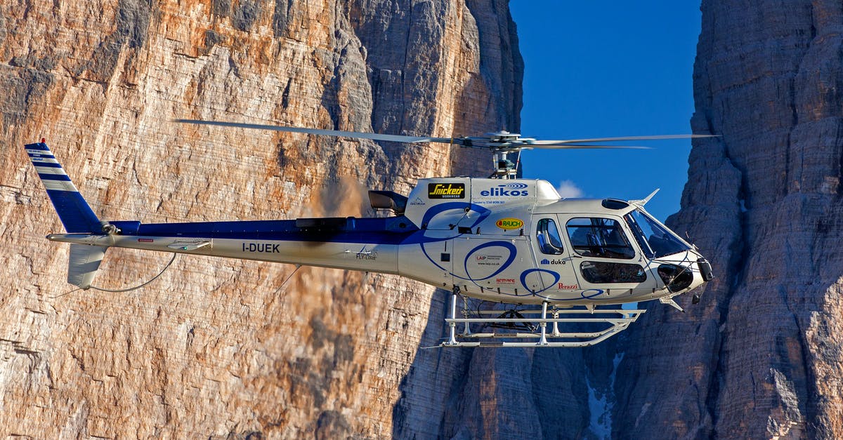 Flight connections between south-west Germany and Corsica? - Selective Photograph of White Helicopter Near Brown Mountains