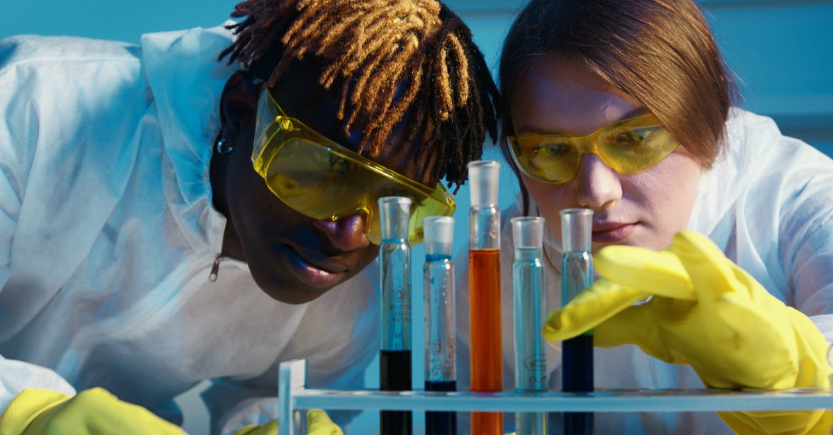 Flight safety and liquid chemicals: 95% alcohol and formol - A Man and a Woman Looking at the Test Tubes