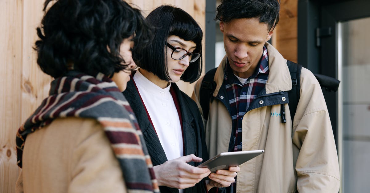 Flight Search Specifying Duration of Stay - Man in Brown Coat Holding Black Tablet Computer