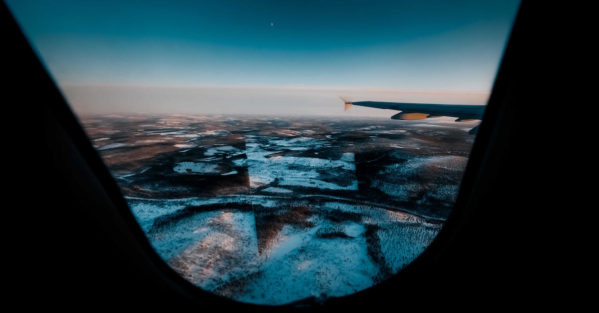 Flights to Greenland - seasonal ex-North America? - Aircraft flying above snowy land under blue sky