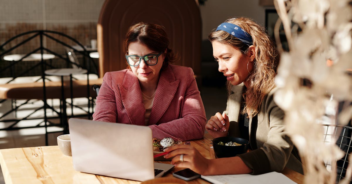 Flights with two different airlines, how does online check-in work? - Woman in Red Knit Sweater Sitting by the Table