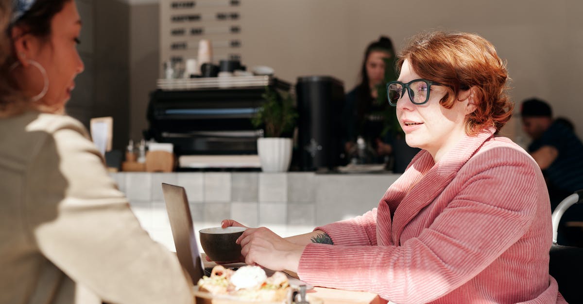 Flights with two different airlines, how does online check-in work? - Woman in Pink Blazer Wearing Green Framed Eyeglasses