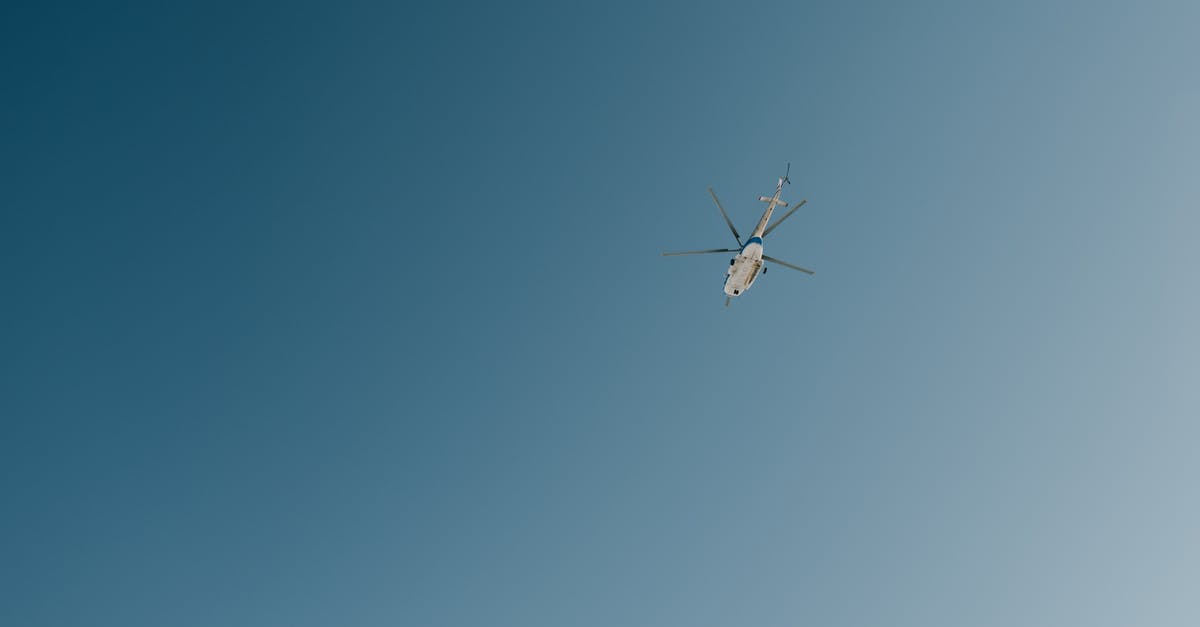 Flying from IAD→YTZ→YHZ—where do I clear Canadian customs? - Helicopter flying in blue cloudless sky