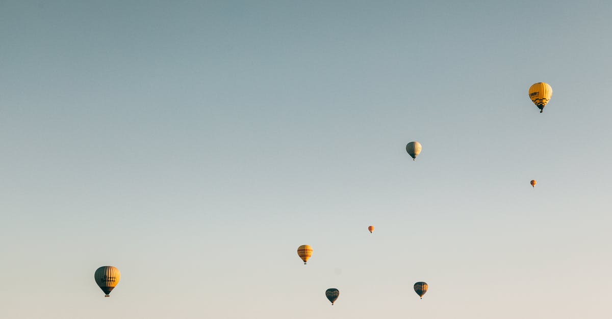 Flying from IAD→YTZ→YHZ—where do I clear Canadian customs? - Colorful air balloons flying in cloudless sky