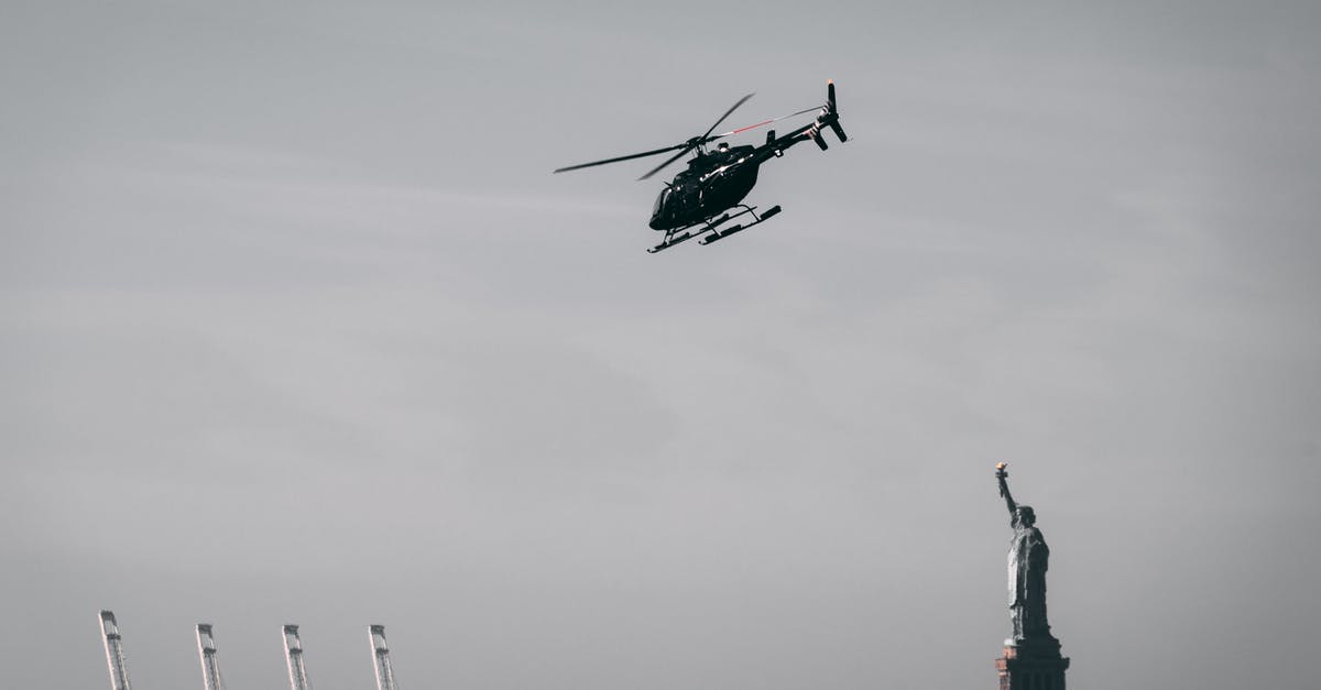 Flying from NYC via Philadelphia to Halifax, I clear Immigration and Customs in Canada? - Photo of a Flying Helicopter Near Statue of Liberty