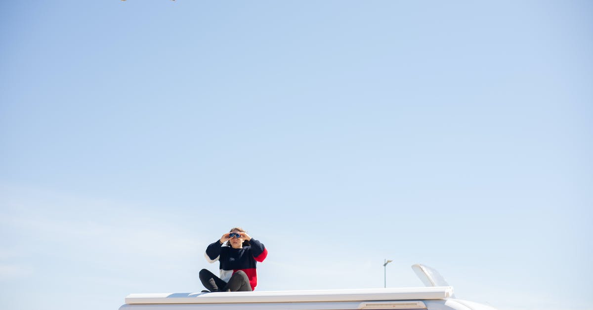 Flying on Southwest with a cat - Man in Black Jacket and Black Pants Sitting on White Boat