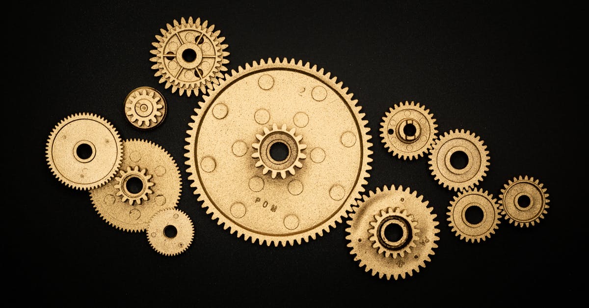 flying out of US with four (4) mechanical keyboards - Photo of Golden Cogwheel on Black Background