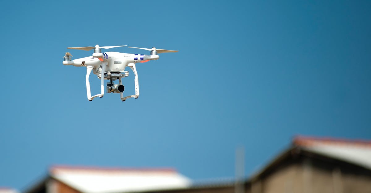 Flying through Frankfurt to Croatia - passport control - Selective Focus Photograph of White Quadcopter Drone during Blue Hour