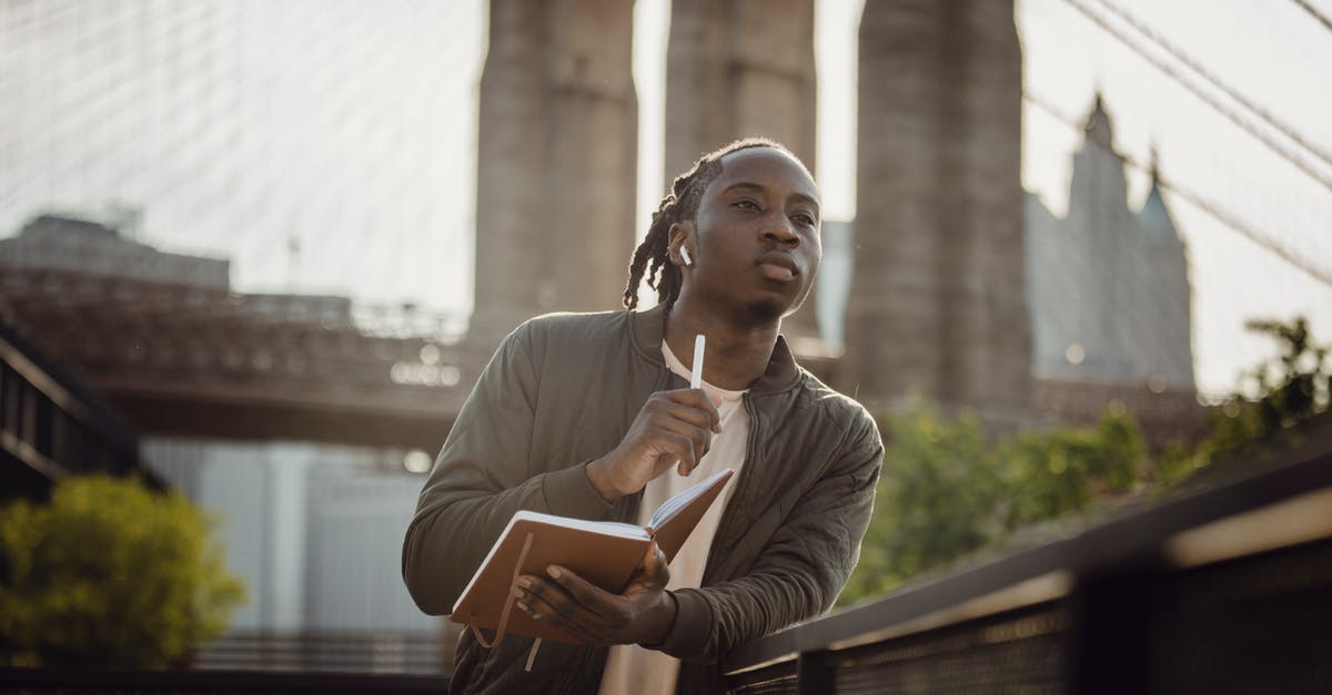 Flying to Russia: Plan additional time for immigration check? - Serious African American guy with planner waiting for meting with planner in downtown