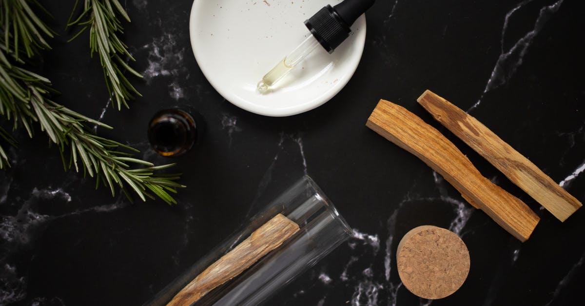 Flying with fragile items on KLM - Glass pipette with aromatic oil in plate near rosemary branches