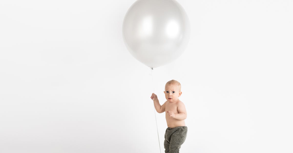 Flying with someone else's children - Baby Holding White Balloon