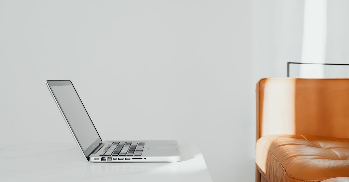 Flying With Uncharged Laptop - Silver Macbook on White Table