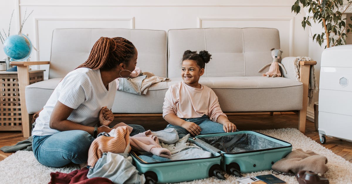 Folding strollers allowed as hand baggage on Norwegian? - Mother and Daughter Packing Clothes 