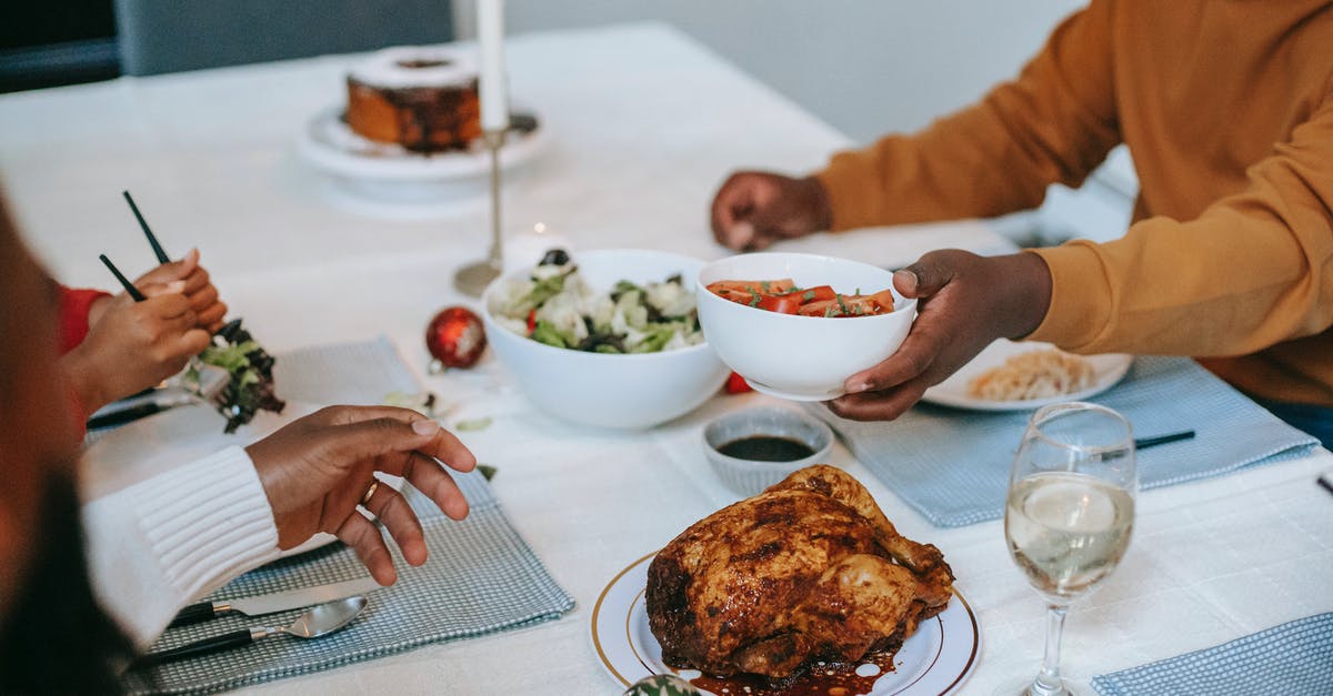 Food imports and exports from Turkey - Crop black relatives at served table with Christmas meal