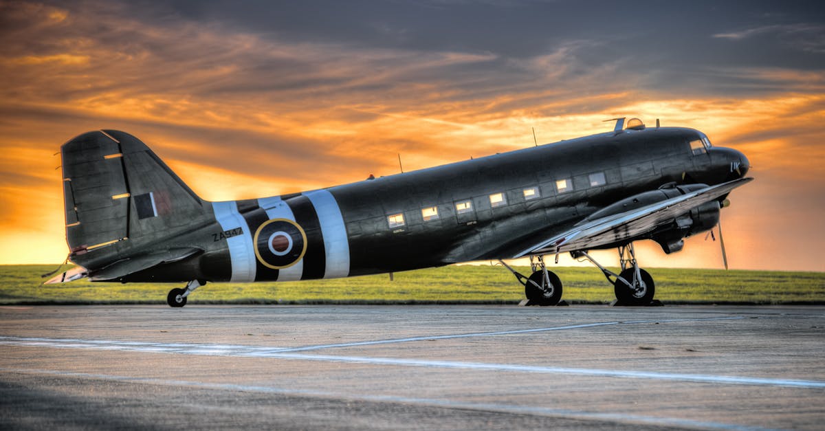 Forceful change of flight schedule by American Airlines - Photo of Black and White Airplane during Golden Hour