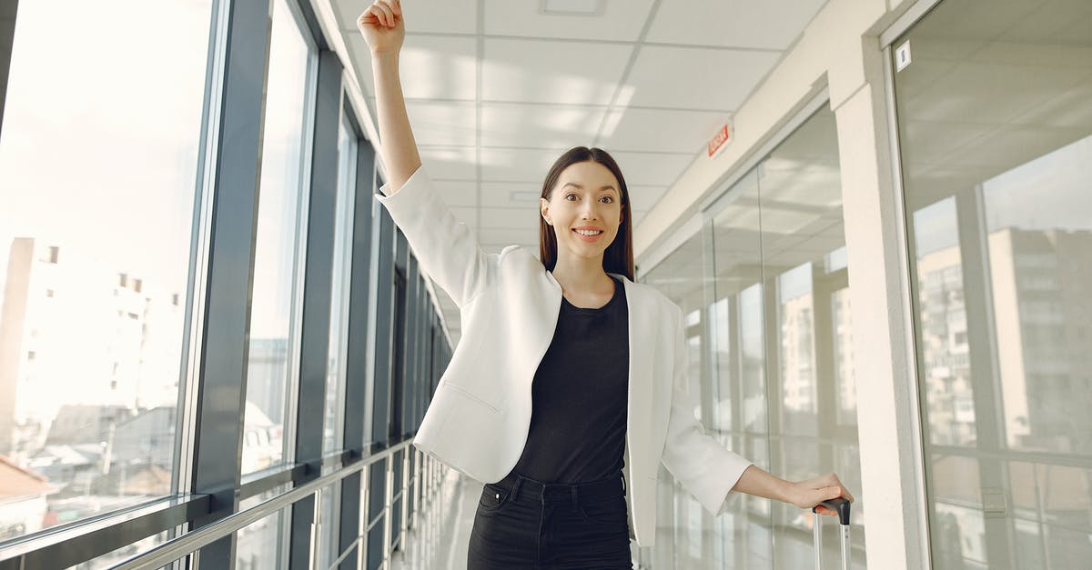 Forgot to include passport information [closed] - Smiling woman showing passport in modern corridor