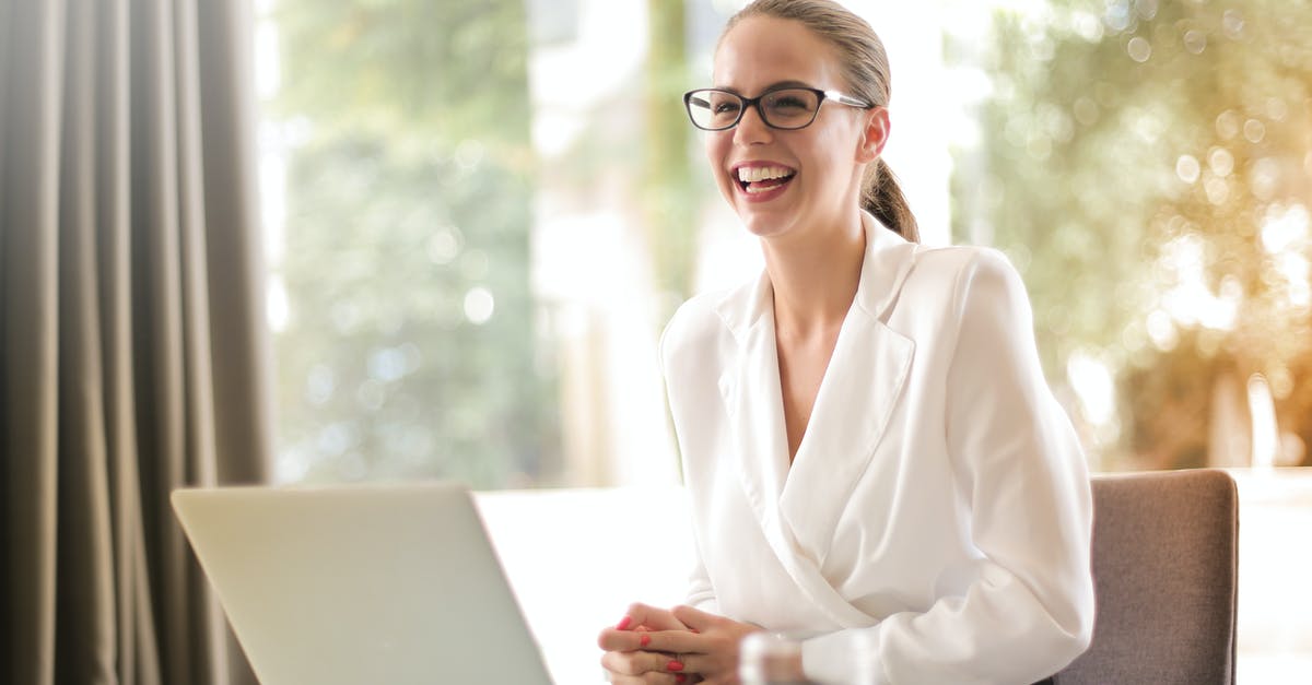 Formal obligation letter or family member? - Laughing businesswoman working in office with laptop