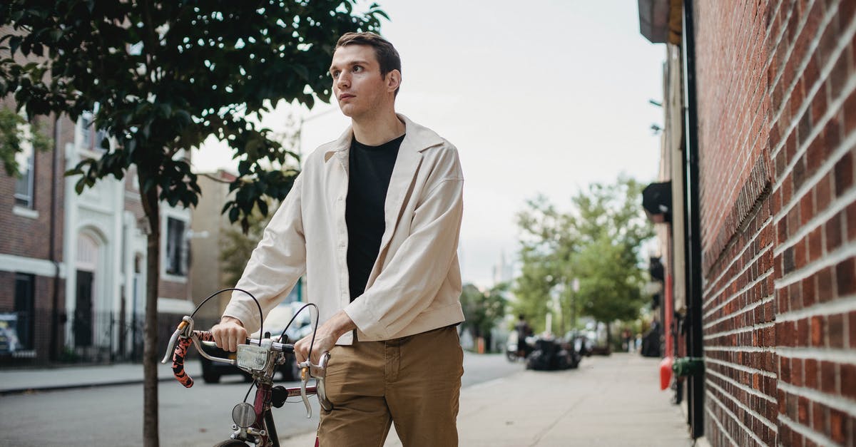 Found a lonely bike in Germany, what to do? [closed] - Happy guy walking with bicycle in street