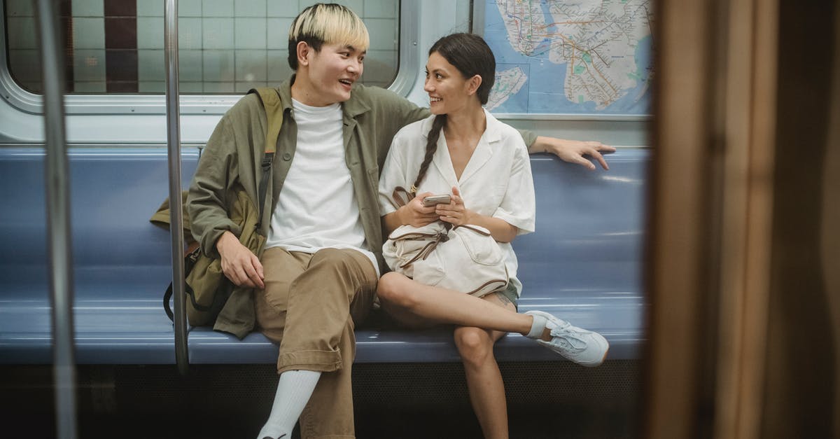 France railway strike affecting my Barcelona to Paris journey. Alternatives? - Happy young ethnic couple sitting in train and talking