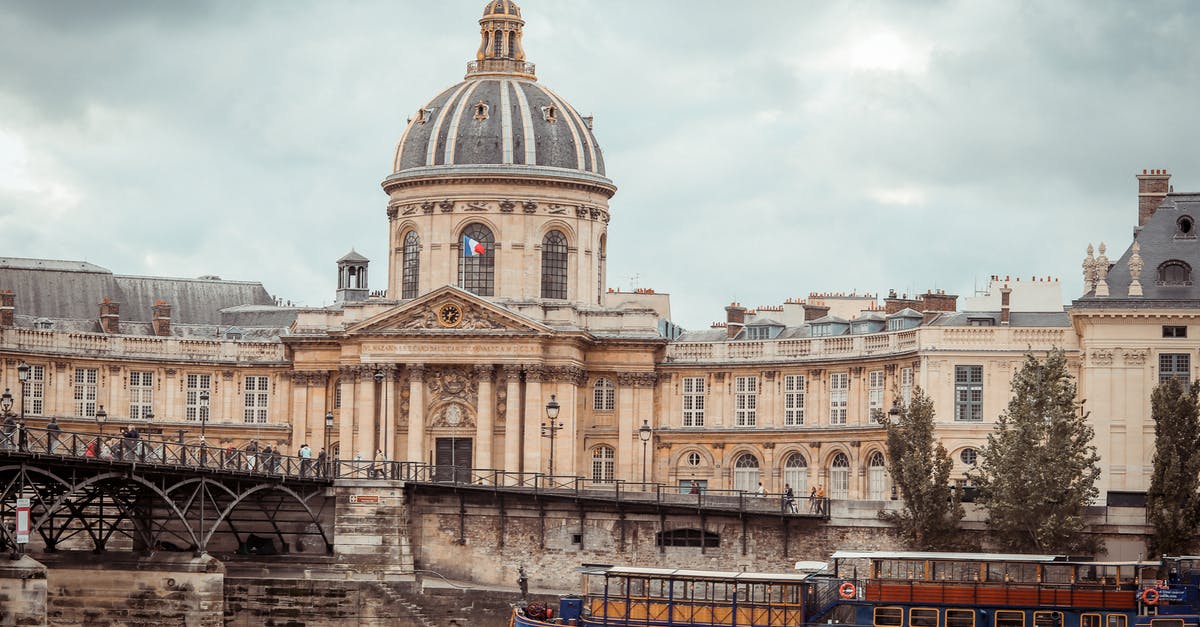 France to USA by ship - Ancient palace on river bank against cloudy sky