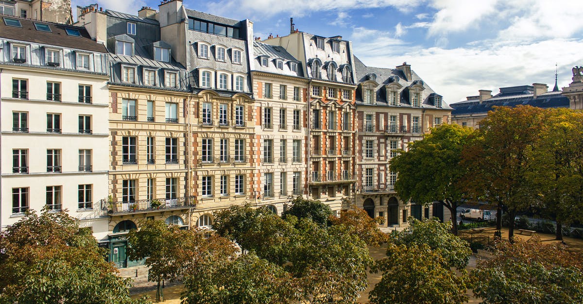 France Visa Query - Concrete Buildings Near Green Trees Under White Clouds