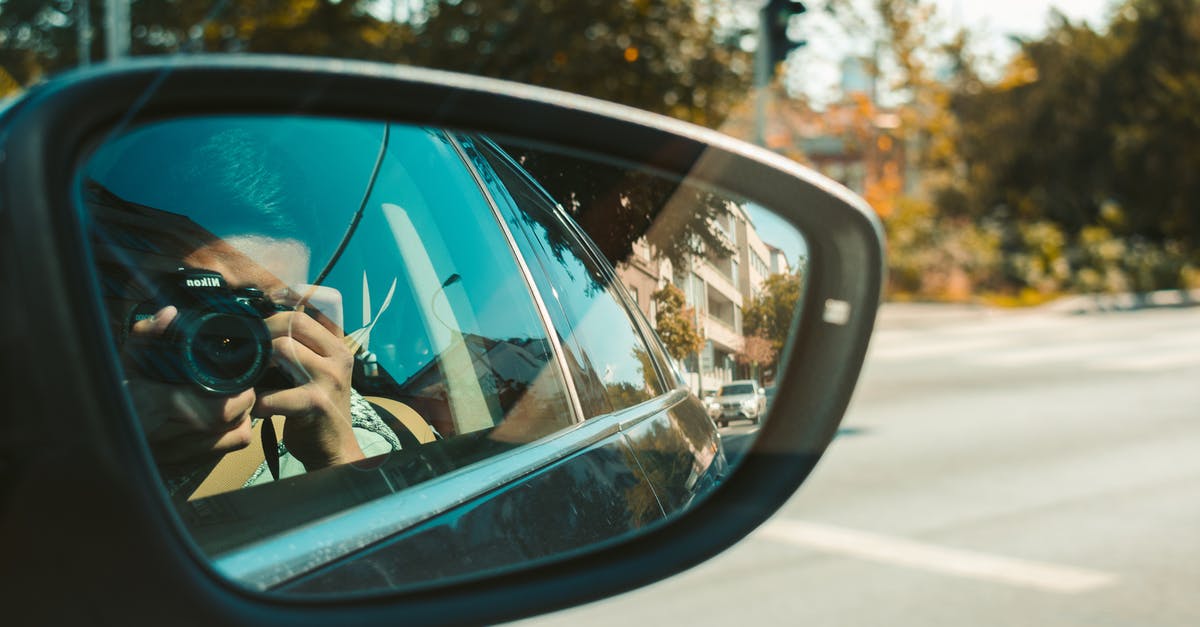 Free floating car sharing in Prague for travelers - Reflection of Man Taking Pictures