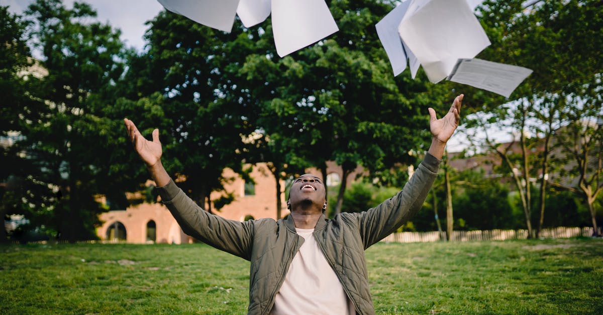 French Pass Sanitaire for travelers coming from outside the EU - Happy young African American male student in casual outfit tossing university papers in air while having fun in green park after successfully completing academic assignments