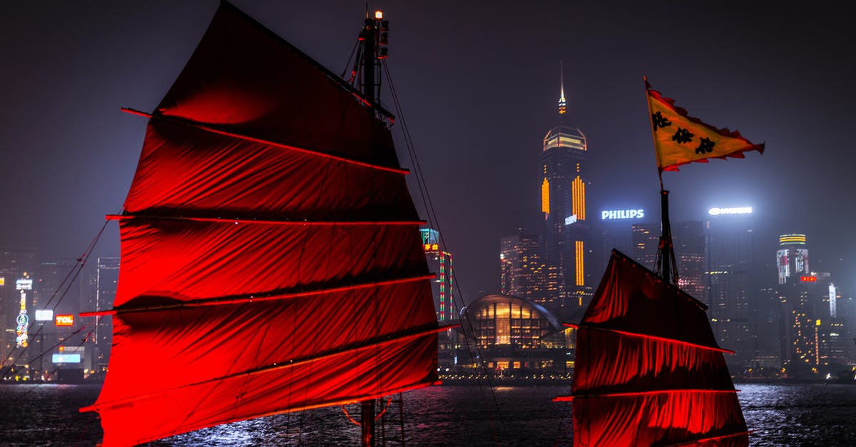From Hong Kong to Macau: Stay over night or do the boat trip every morning? - Red Sail Boat on Body of Water Near City Buildings during Night Time