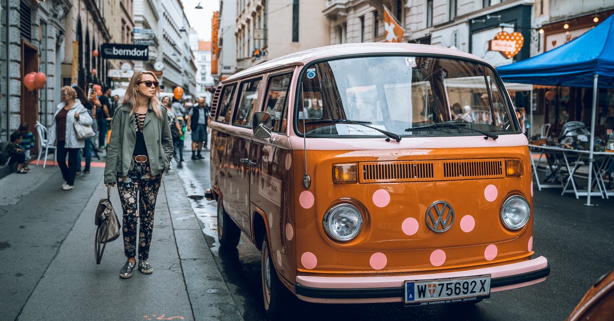 From Italy to Austria during winter, by car - Orange Volkswagen Van